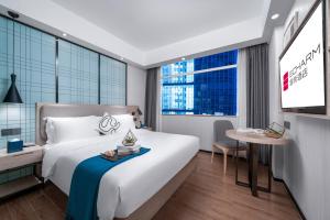 Postel nebo postele na pokoji v ubytování Borrman International Hotel Guangzhou Beijing Road Pedestrian Street Donghu Metro Station Branch - Free Shuttle Bus to Canton Fair Complex During Canton Fair Period