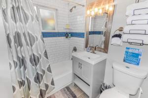 a bathroom with a sink and a toilet and a shower at Stylish One-Bedroom Unit with Easy Ground Access in Reno