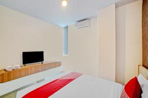 Postel nebo postele na pokoji v ubytování Super OYO 90559 Gamacity Residence