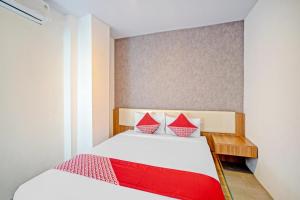 Postel nebo postele na pokoji v ubytování Super OYO 90559 Gamacity Residence