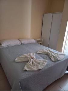a bed with two dirty clothes on top of it at Hotel Valle Hermoso in San Agustín de Valle Fértil