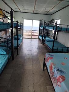 a room with bunk beds with a view of the ocean at Calishores Beachfront Resort in Morong