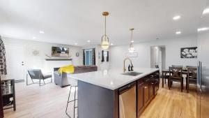 a kitchen and living room with a sink and a table at Spacious Family Retreat in Denver in Denver