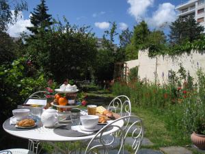 a table with a plate of food on it at Le Petit Quernon in Angers