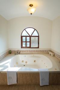 a large bath tub in a bathroom with a window at Hacienda San Antonio in Kanasín