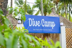 a sign for a dive camp at a resort at Dive Camp in Dauin