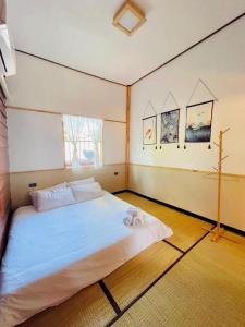a bedroom with a large white bed in it at บ้านปู่ทอง Grandpa's House in Chiang Khan +18 photos