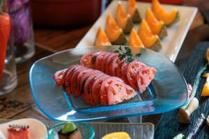 a plate of food on a table with oranges at Biei Shirogane Onsen Hotel Park Hills in Biei +72 photos