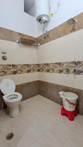 a bathroom with a toilet and a sink at LD Guest House, Ayodhya in Ayodhya