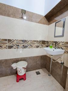 a bathroom with a toilet and a sink at LD Guest House, Ayodhya in Ayodhya