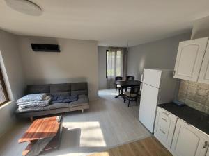 a living room with a couch and a table at Уютен Апартамент in Sofia