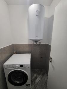 a washer and dryer in a small bathroom at Уютен Апартамент in Sofia