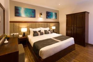 Postel nebo postele na pokoji v ubytování Hotel Grand Turf By GSP