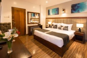 Postel nebo postele na pokoji v ubytování Hotel Grand Turf By GSP