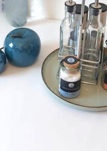 a glass bottle on a table with a blue object at Schönes Apartment in Top-Lage Karlsruhe in Karlsruhe