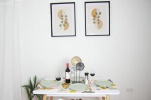 a white table with plates and wine glasses on it at Schönes Apartment in Top-Lage Karlsruhe in Karlsruhe