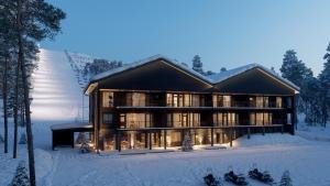 a house in the snow with skis in the snow at Fjällen Aurora Luxe Chalet Ski-in Ski-out by Aavalevi in Levi