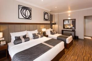Postel nebo postele na pokoji v ubytování Hotel Grand Turf By GSP