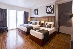 Postel nebo postele na pokoji v ubytování Hotel Grand Turf By GSP