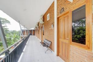 a balcony with two chairs on a building at Hotel O D Kost In Kandri Semarang in Semarang