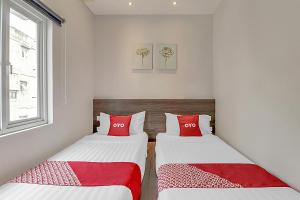 A bed or beds in a room at Collection O Cihampelas Near Ciwalk Formerly Regia Cihampelas