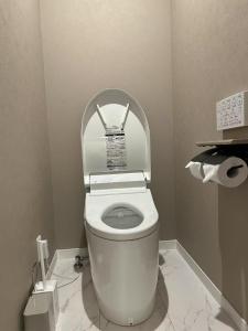 a bathroom with a toilet with a sign above it at ASOBO OSAKA Kuromon 2nd in Osaka