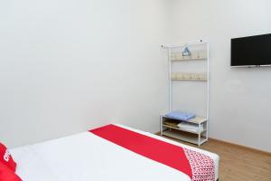 Postel nebo postele na pokoji v ubytování Capital O 90406 Mirani Hotel