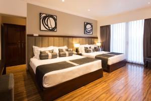 Postel nebo postele na pokoji v ubytování Hotel Grand Turf By GSP