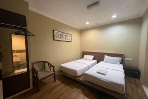 Postel nebo postele na pokoji v ubytování OYO 90411 Perdana Hotel Labuan