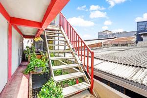 a staircase on a building with plants on it at Hotel O Griyo Sonia in Surabaya