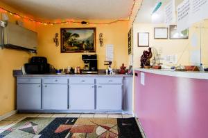 a kitchen with white cabinets and a counter at OYO Hotel Chapmanville Inn, WV - Hwy 119 in Chapmanville
