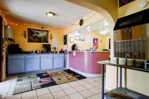 a kitchen with blue cabinets and a counter in a room at OYO Hotel Chapmanville Inn, WV - Hwy 119 in Chapmanville +31 photos