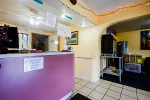 a restaurant with a purple counter in a room at OYO Hotel Chapmanville Inn, WV - Hwy 119 in Chapmanville