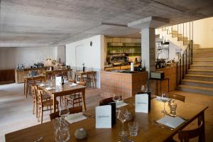 a restaurant with wooden tables and chairs and a staircase at TREMONDI - Boutique BnB in Quarten