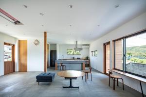 a living room with a table and a kitchen at terya in Amami