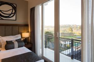 Postel nebo postele na pokoji v ubytování Hotel Grand Turf By GSP