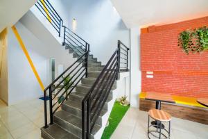 a staircase in a house with a brick wall at Collection O Millenium Inn 2 in Medan