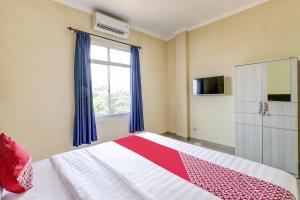 Postel nebo postele na pokoji v ubytování SUPER OYO 90905 Dangau Datuk Guesthouse + 22 fotografií