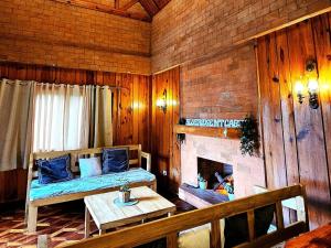 a living room with a couch and a fireplace at Couple Room 2C Transient Baguio Wifi Parking in Baguio