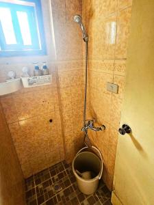 a small bathroom with a toilet in a shower at Couple Room 2C Transient Baguio Wifi Parking in Baguio