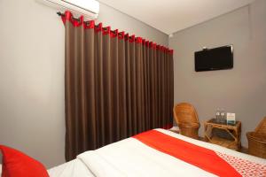 Postel nebo postele na pokoji v ubytování OYO 587 Hotel Tradition Inn