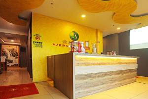 a counter in a restaurant with a yellow wall at Hotel O Marina World in Kuching