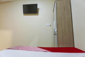Ein Bett oder Betten in einem Zimmer der Unterkunft OYO 90981 X2 Homestay
