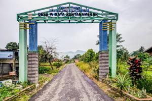 an archway over a road in a village at OYO Homes 91067 Desa Wisata Santanamekar in Rajapolah