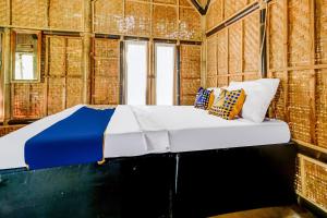 a bedroom with a bed in a brick wall at OYO Homes 91067 Desa Wisata Santanamekar in Rajapolah +29 photos