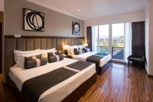 Postel nebo postele na pokoji v ubytování Hotel Grand Turf By GSP