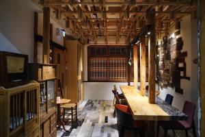 a dining room with a wooden table and chairs at Spring12 House in Chiayi City