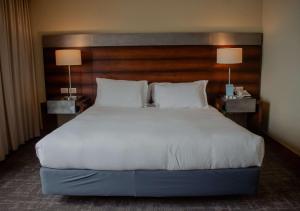 a large bed in a hotel room with two lamps at Radisson Hotel Puerto Varas in Puerto Varas +86 photos