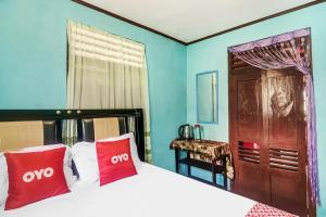 Postel nebo postele na pokoji v ubytování OYO Homes 91148 Homesstay Desa Wisata Bahoi Near Ekowisata Mangrove Desa Bahoi + 18 fotografií