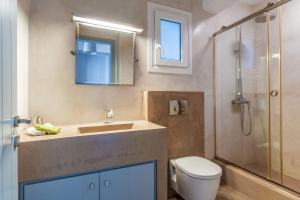 a bathroom with a toilet and a sink and a shower at Vassilis Family Villa Tinos in Triandáros +17 photos